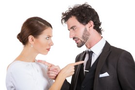 couple pointing fingers at each other, blaming each other